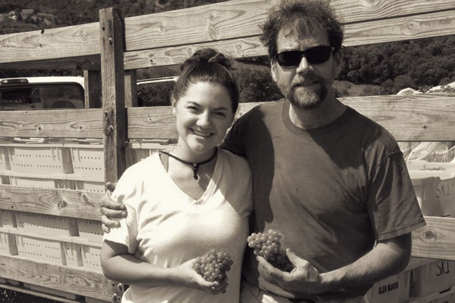 Glen Manor Vineyards owners holding freshly harvested grapes in the vineyard