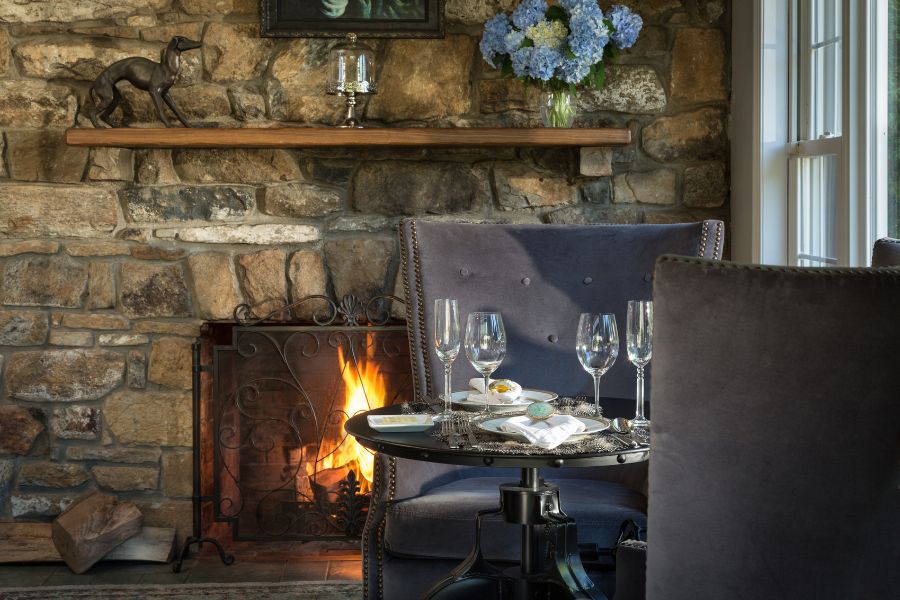 Houndstooth Restaurant dining area with wine and fireplace