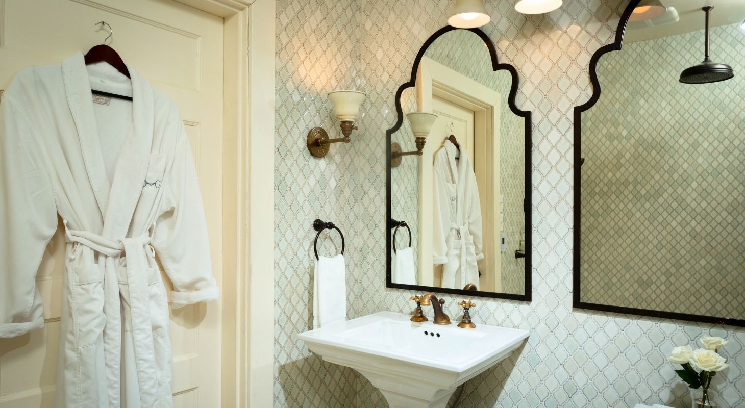 Luxurious guest bathroom with soaking tub and robes at Glen Gordon Manor