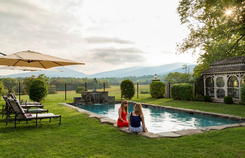 Women Relaxing by Pool with Gorgeous Views