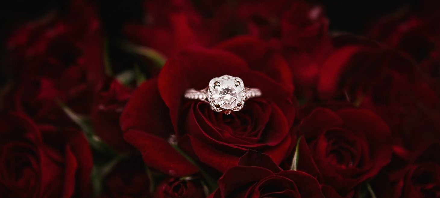 Gorgeous diamond engagement ring in a bouquet of roses