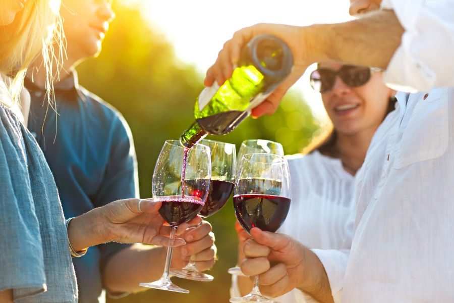 a group of people drinking wine