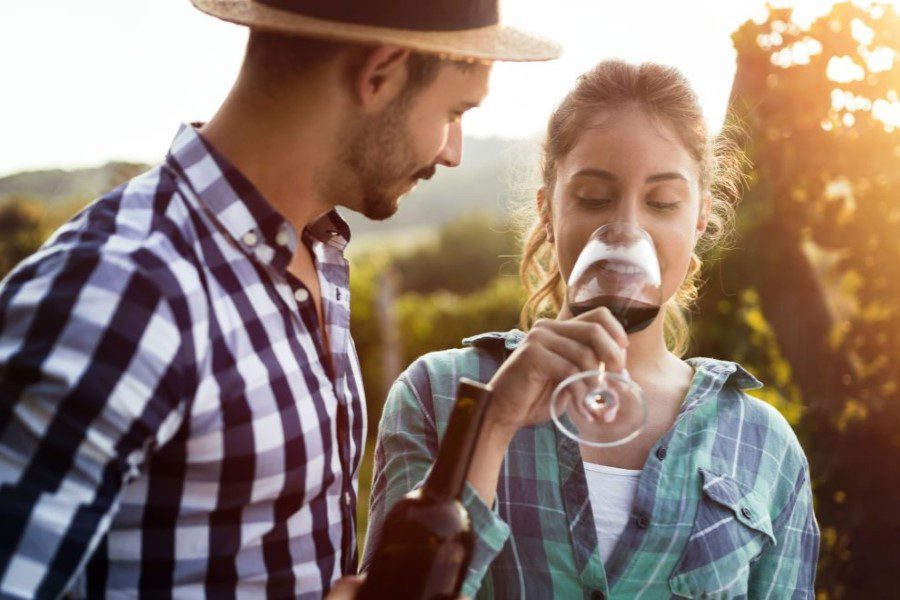 a couple tasting wine at a winery during a fall getaway from DC