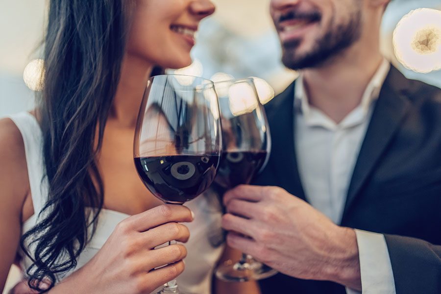 Happy couple with glasses of red wine