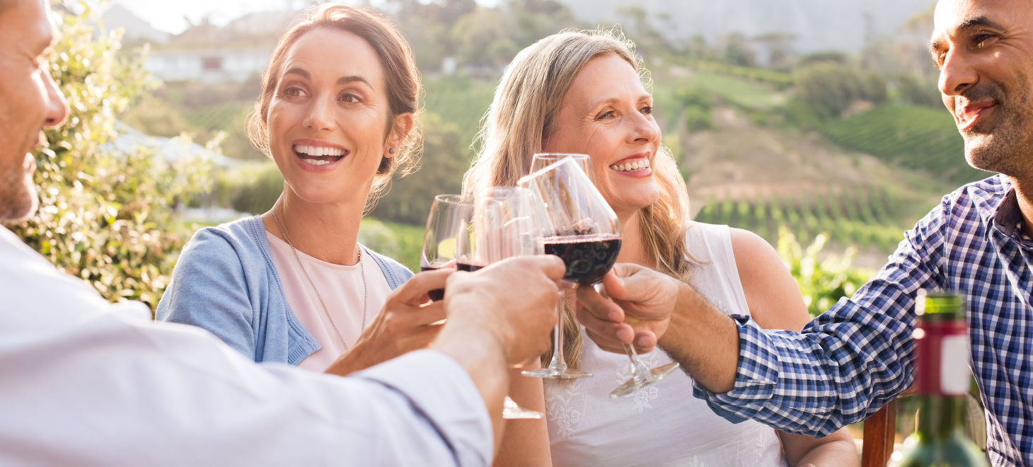 Happy group of people toasting red wine at a winery in Virginia