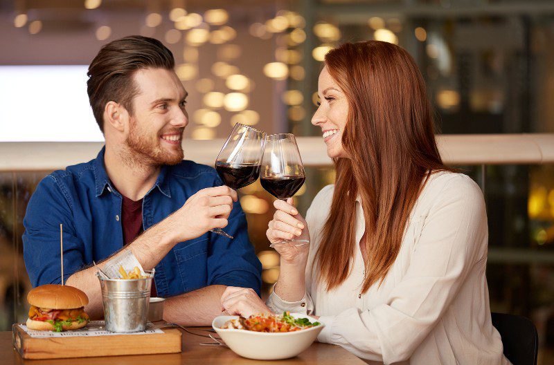 couple drinking red wine and dining