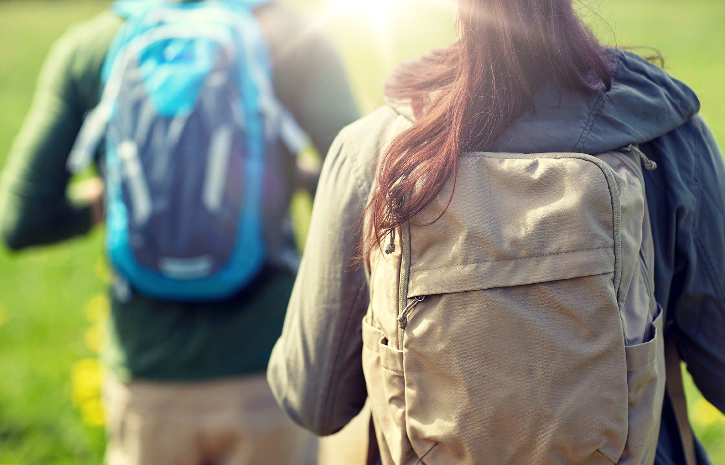 close up of couple hiking back packs