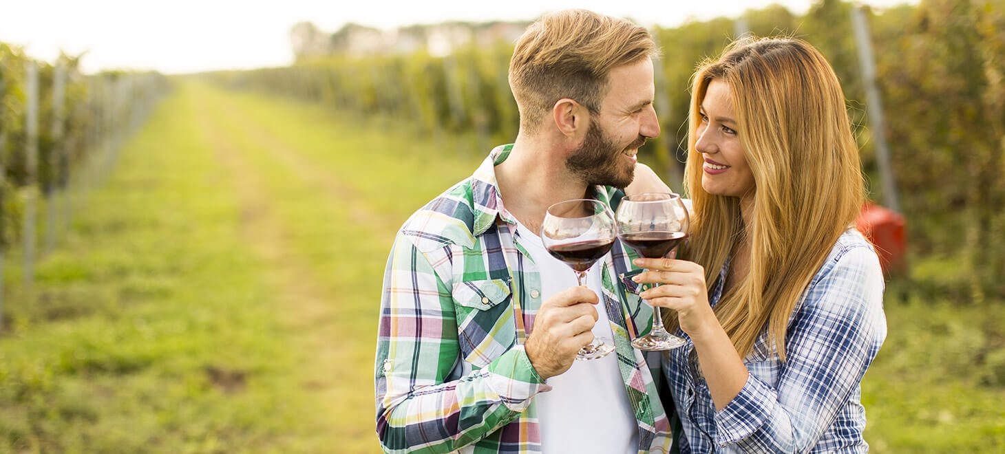 couple drinking red wine at winery