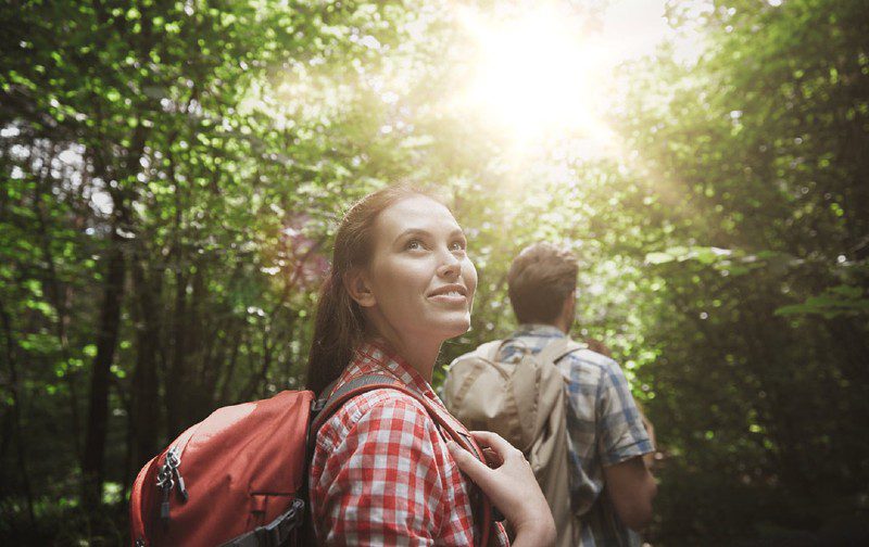 couple hiking sun shining