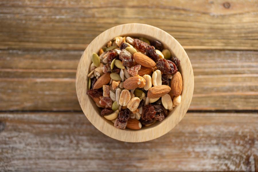 bowl of trail mix on a wooden table