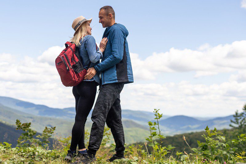 couple embracing while on a hike