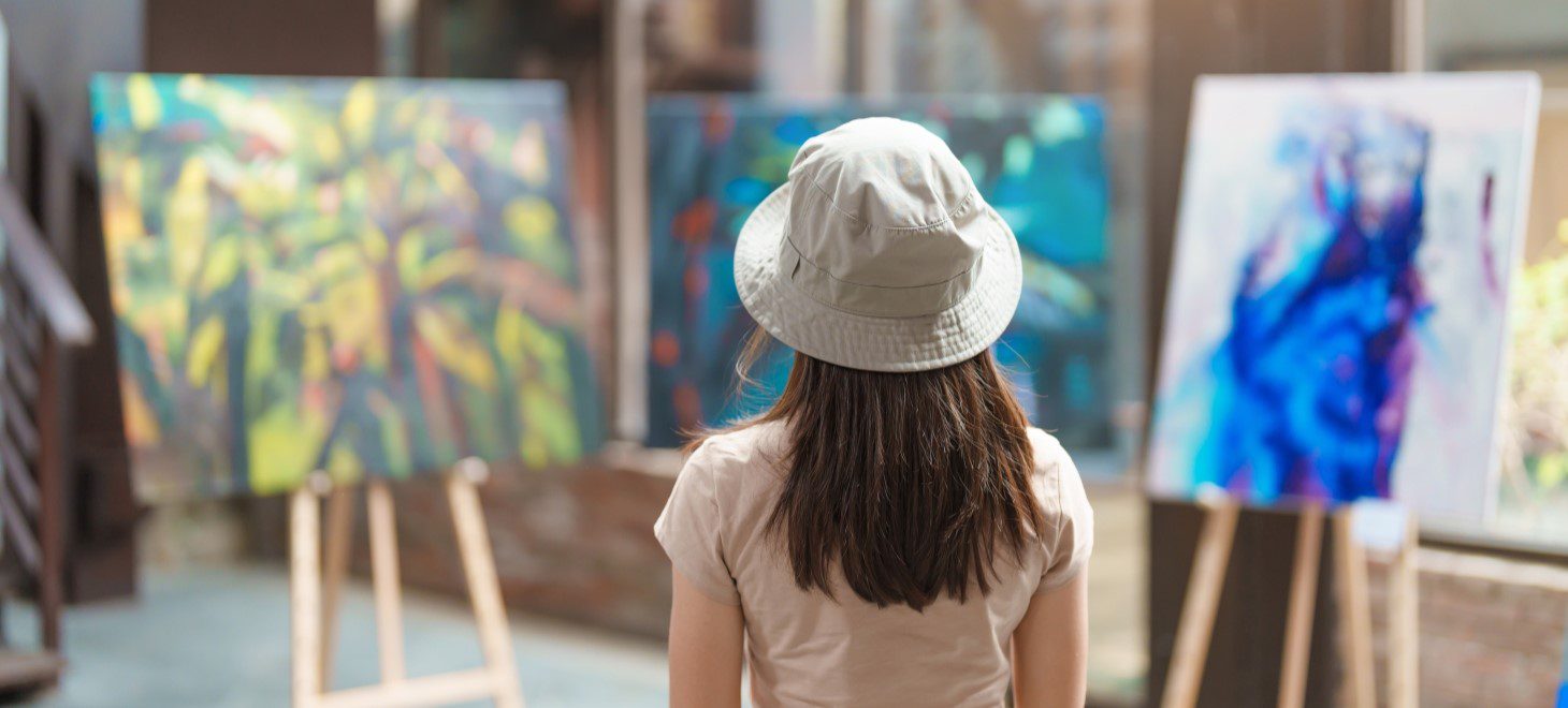 a woman looking at art in a gallery near Glen Gordon Manor