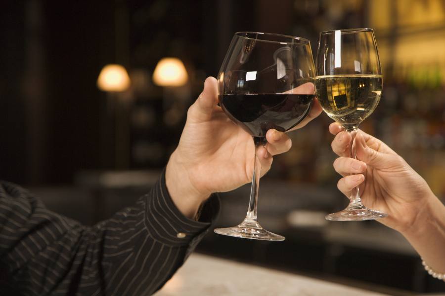 Two people toasting wine glasses