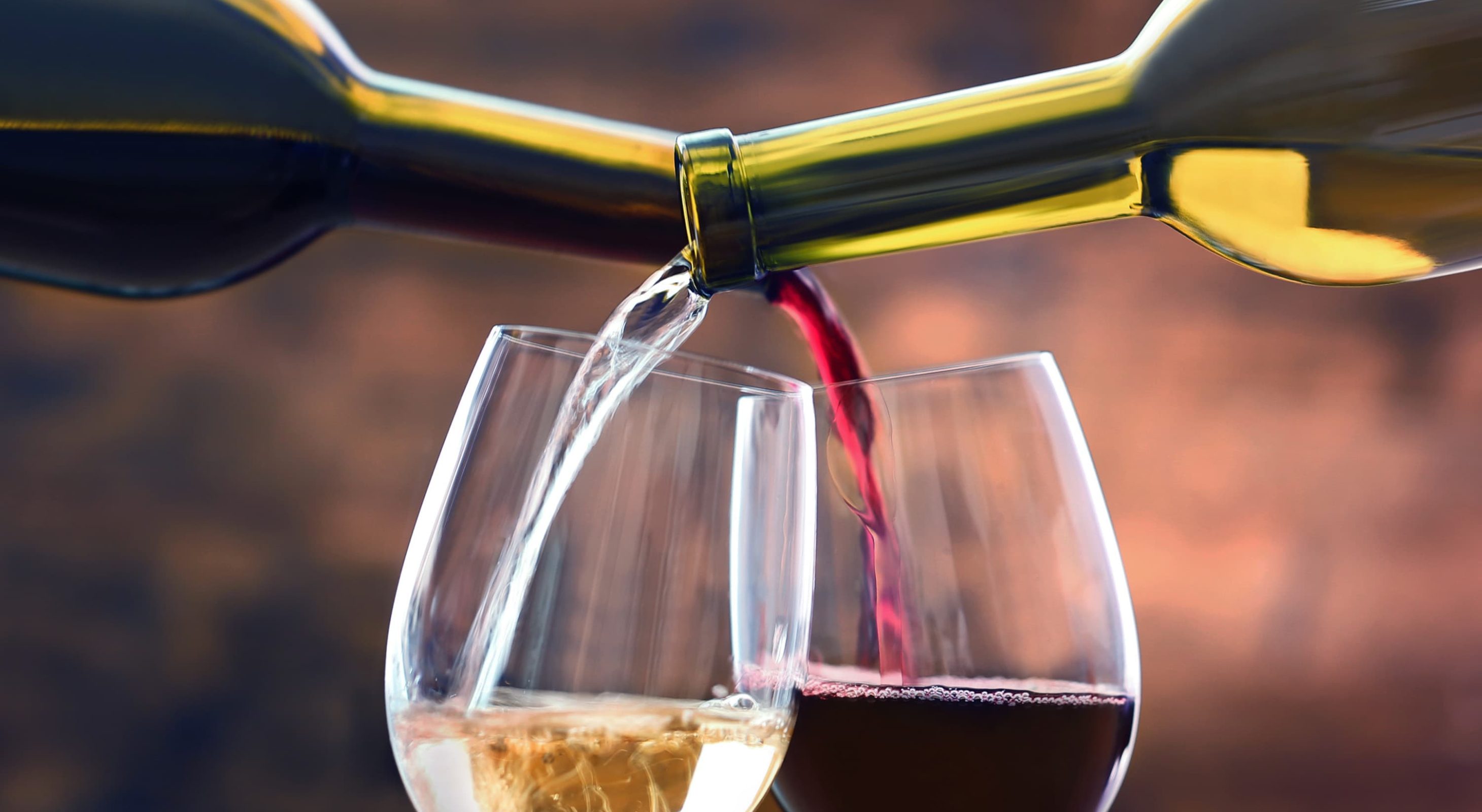 red and white wine being poured into glasses