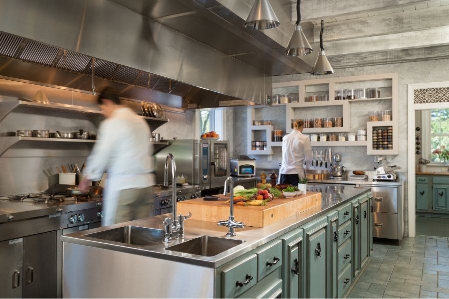 Chef Dayn Smith preparing gourmet dishes in the kitchen at Houndstooth Restaurant, Glen Gordon Manor