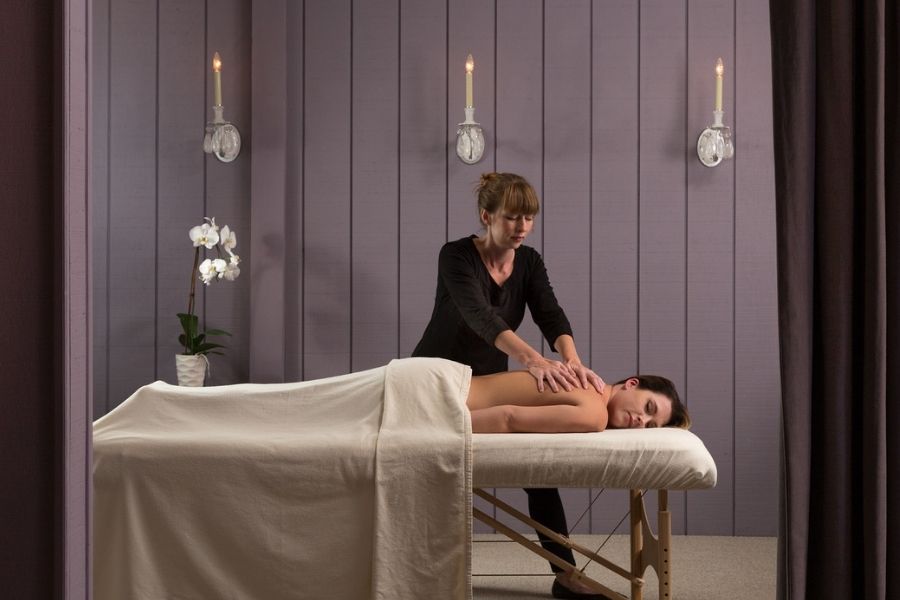 Couple relaxing side by side during a Swedish massage at a private spa on a romantic getaway in Virginia