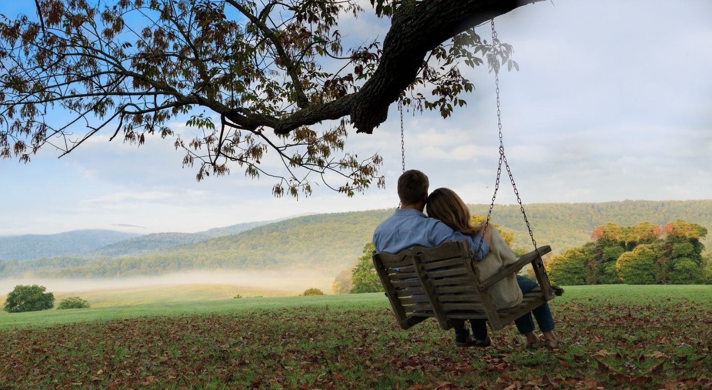 Couple exploring scenic trails near the Blue Ridge Mountains before returning to a luxurious Virginia inn