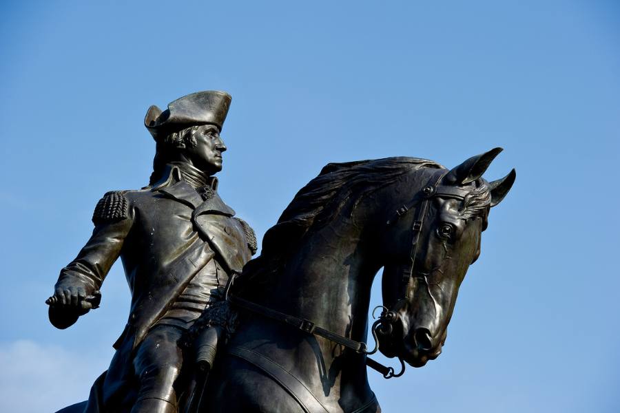 Statue of George Washington against a blue sky